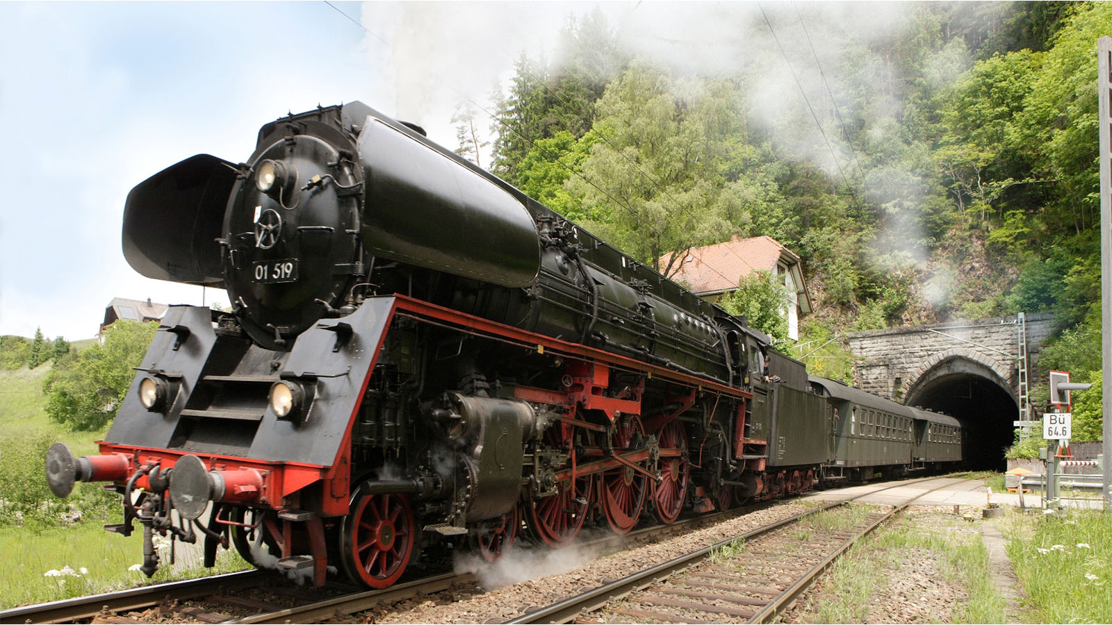 Dynamische Aufnahme einer historischen Eisenbahn, die aus einem Tunnel herausfährt